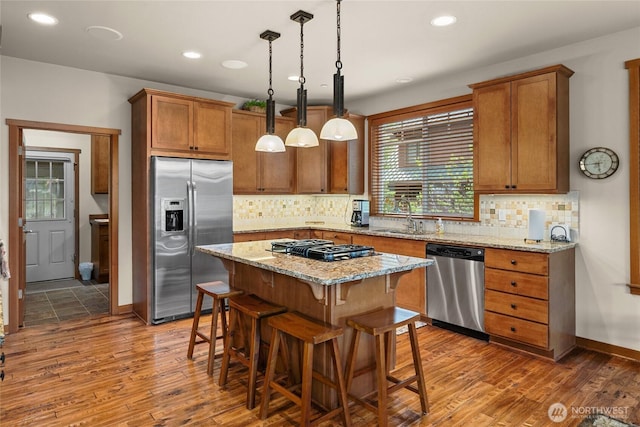 2101 Coal Mine Way, Cle Elum, WA 98922 - kitchen with stainless steel appliances, a sink, wood finished floors, brown cabinetry, and recessed lighting