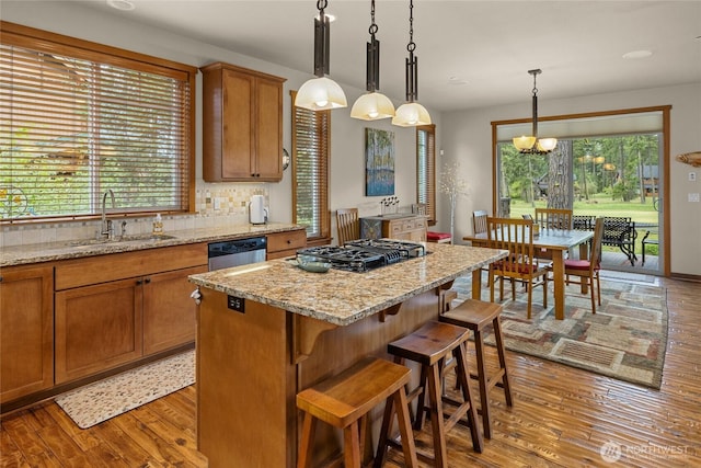 2101 Coal Mine Way, Cle Elum, WA 98922 - kitchen with a sink, black gas cooktop, brown cabinetry, stainless steel dishwasher, and plenty of natural light