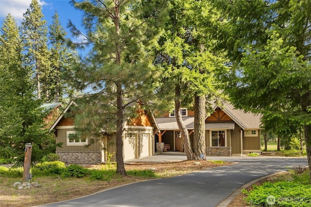 2101 Coal Mine Way, Cle Elum, WA 98922 - view of front of house with stone siding, driveway, and board and batten siding