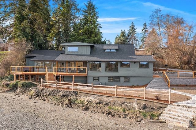 8811 SW Quartermaster Dr, Vashon, WA 98070 - back of house featuring stairway, a wooden deck, a sunroom, and a shingled roof