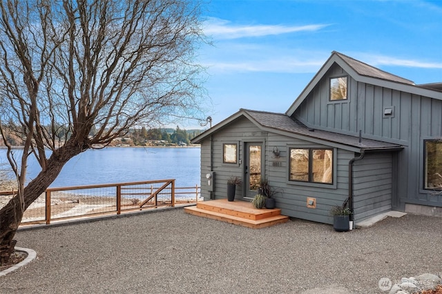 8811 SW Quartermaster Dr, Vashon, WA 98070 - view of front of home with board and batten siding, a water view, and roof with shingles
