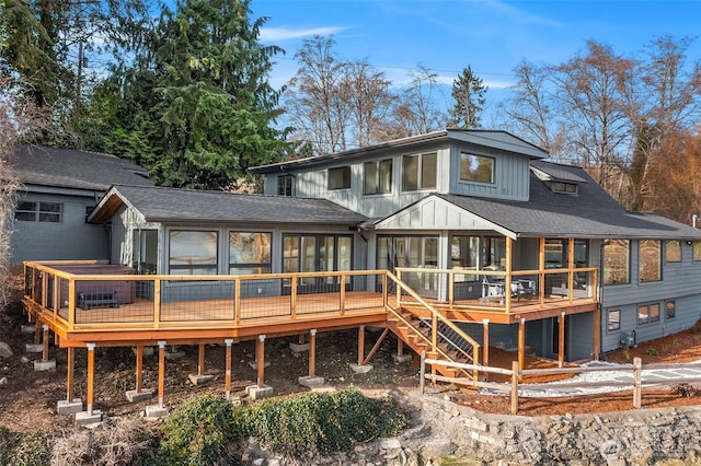 8811 SW Quartermaster Dr, Vashon, WA 98070 - rear view of property featuring a sunroom, a wooden deck, board and batten siding, and a shingled roof