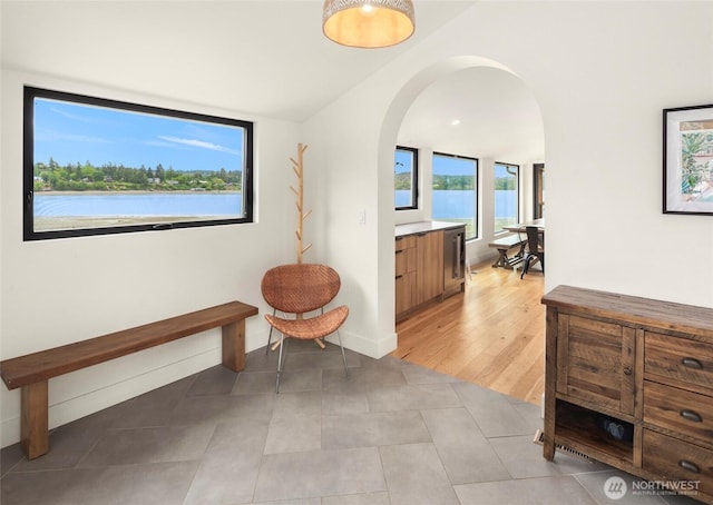 8811 SW Quartermaster Dr, Vashon, WA 98070 - hallway featuring arched walkways and light tile patterned floors