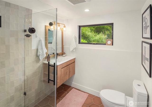 8811 SW Quartermaster Dr, Vashon, WA 98070 - bathroom with vanity, toilet, a tile shower, tile patterned floors, and recessed lighting