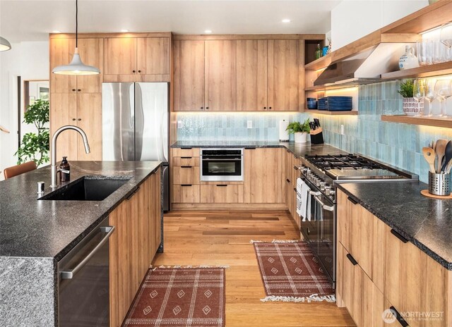 8811 SW Quartermaster Dr, Vashon, WA 98070 - kitchen with a sink, stainless steel appliances, open shelves, light wood-type flooring, and tasteful backsplash