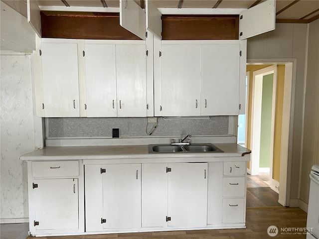 211 E Cherry St, Centralia, WA 98531 - kitchen featuring a sink, wood finished floors, light countertops, and white cabinets