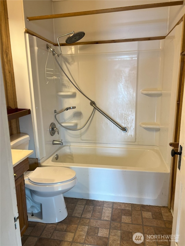211 E Cherry St, Centralia, WA 98531 - bathroom featuring shower / washtub combination, toilet, vanity, and brick patterned flooring