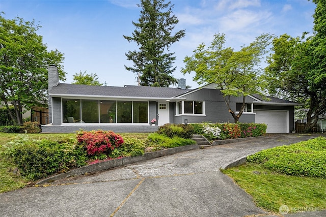 2228 Cinkovich St, Enumclaw, WA 98022 - view of front of property featuring a chimney, an attached garage, brick siding, and driveway