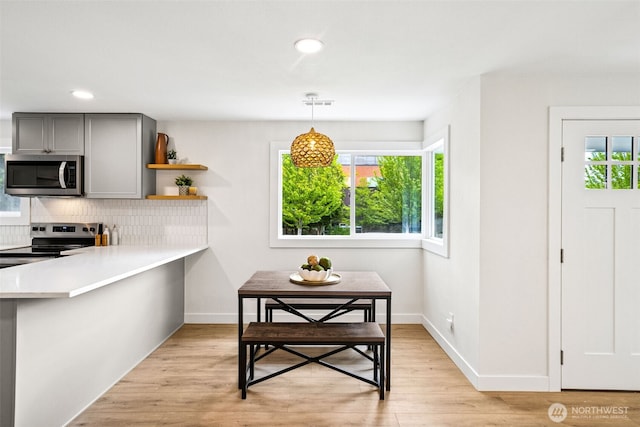 2228 Cinkovich St, Enumclaw, WA 98022 - kitchen featuring stainless steel appliances, gray cabinetry, plenty of natural light, backsplash, and recessed lighting