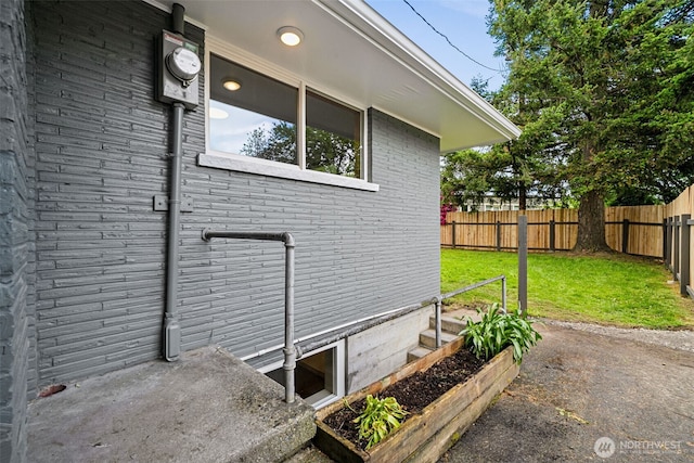 2228 Cinkovich St, Enumclaw, WA 98022 - view of home's exterior featuring brick siding and a garden