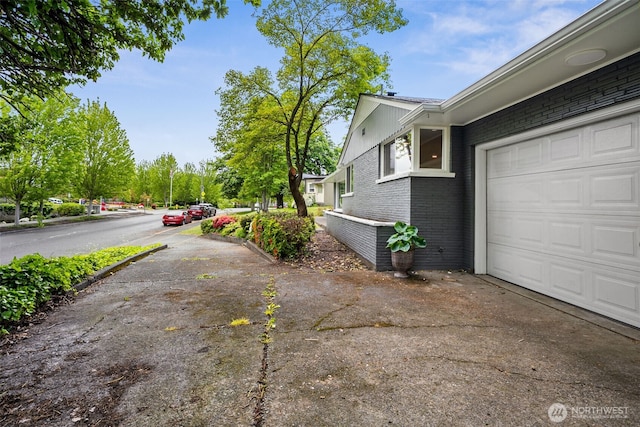 2228 Cinkovich St, Enumclaw, WA 98022 - view of side of property featuring driveway, brick siding, and a garage