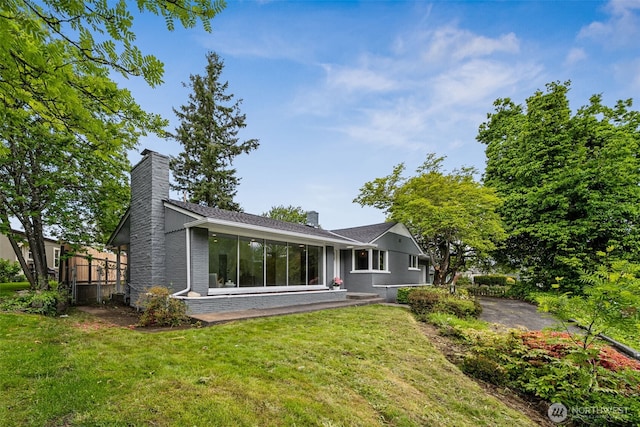 2228 Cinkovich St, Enumclaw, WA 98022 - back of house with a chimney, a yard, and brick siding