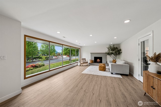 2228 Cinkovich St, Enumclaw, WA 98022 - living room with a warm lit fireplace, wood finished floors, and recessed lighting