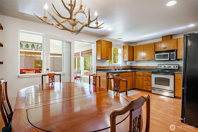 8459 Catalina Ct, Blaine, WA 98230 - dining area featuring a chandelier, recessed lighting, and light wood-style flooring