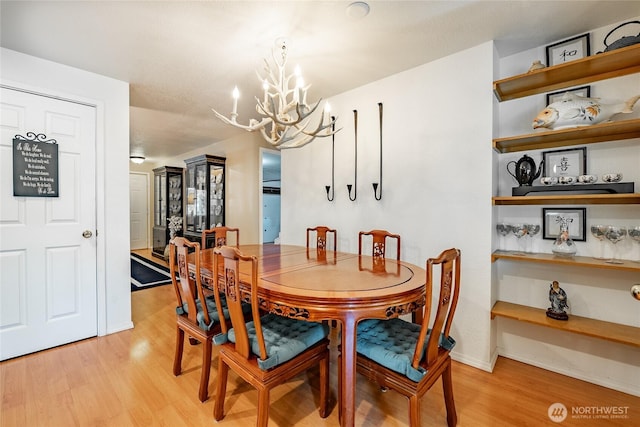 8459 Catalina Ct, Blaine, WA 98230 - dining room featuring a chandelier and light wood finished floors