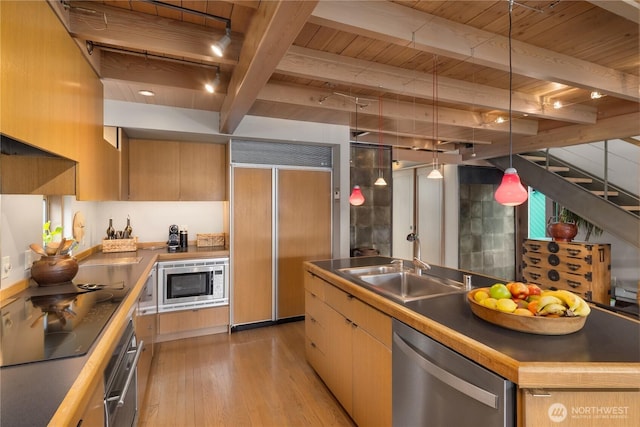 2466 Westlake Ave N Unit 5, Seattle, WA 98109 - kitchen featuring built in appliances, wood ceiling with exposed beams, light wood finished floors, modern cabinets, and hanging light fixtures