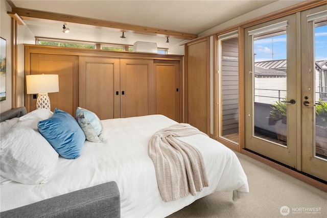 2466 Westlake Ave N Unit 5, Seattle, WA 98109 - bedroom featuring access to outside, beamed ceiling, french doors, and light colored carpet