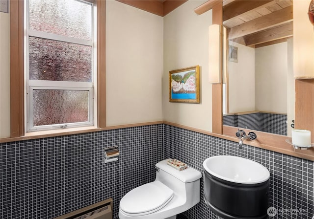 2466 Westlake Ave N Unit 5, Seattle, WA 98109 - bathroom with toilet, wainscoting, healthy amount of natural light, tile walls, and beamed ceiling