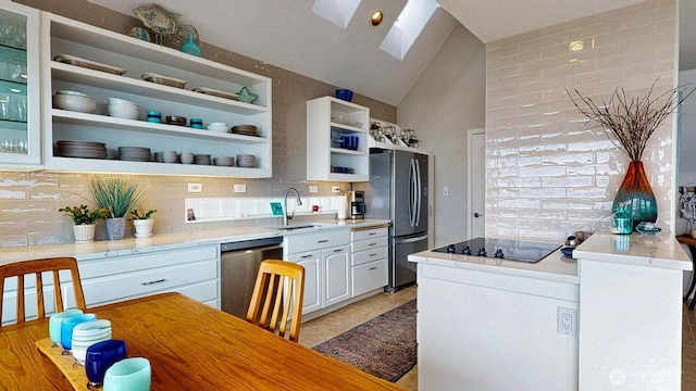 14028 Evergreen Way, Stanwood, WA 98292 - kitchen featuring stainless steel appliances, a sink, open shelves, a skylight, and vaulted ceiling