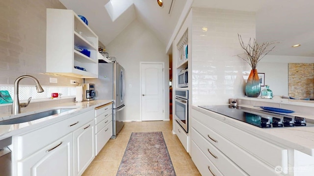 14028 Evergreen Way, Stanwood, WA 98292 - kitchen featuring appliances with stainless steel finishes, a sink, light stone countertops, open shelves, and white cabinets