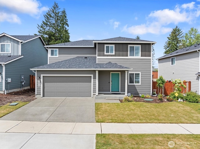 15013 Iverson Loop SE, Yelm, WA 98597 - traditional-style house with an attached garage, concrete driveway, board and batten siding, and a shingled roof