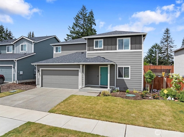 15013 Iverson Loop SE, Yelm, WA 98597 - traditional-style home with a garage, board and batten siding, driveway, and a shingled roof