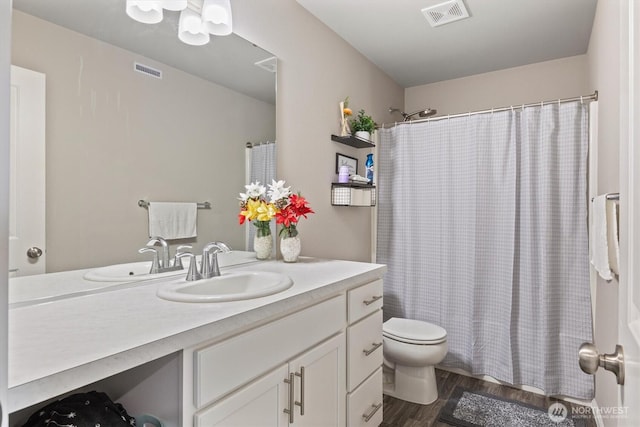 15013 Iverson Loop SE, Yelm, WA 98597 - bathroom featuring vanity, toilet, wood finished floors, and shower / tub combo