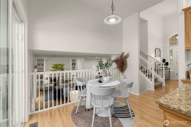 2024 N 145th St, Shoreline, WA 98133 - dining area featuring a towering ceiling, light wood-style flooring, and stairway