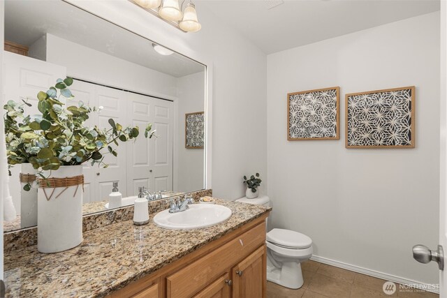 2024 N 145th St, Shoreline, WA 98133 - bathroom with toilet, vanity, tile patterned flooring, and baseboards
