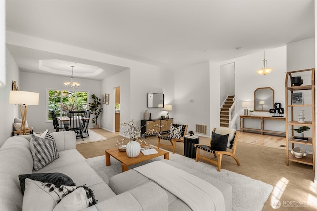 2024 N 145th St, Shoreline, WA 98133 - living room with stairs, a chandelier, a tray ceiling, and baseboards