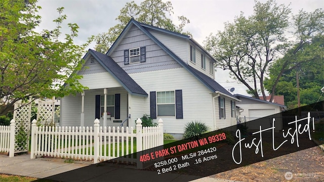 405 E Park St, Dayton, WA 99328 - view of front facade featuring a porch, a fenced front yard, a detached garage, and roof with shingles