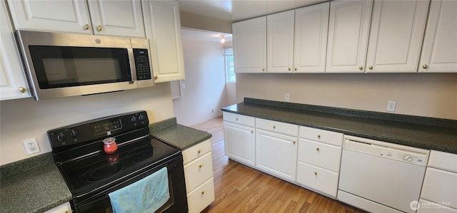 405 E Park St, Dayton, WA 99328 - kitchen with stainless steel microwave, black range with electric stovetop, white dishwasher, and white cabinets