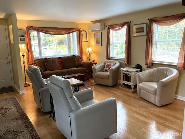 1403 Thomas St, Port Townsend, WA 98368 - living area with a wall mounted air conditioner, healthy amount of natural light, and light wood-style floors