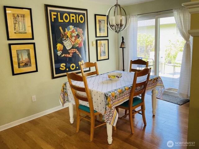 1403 Thomas St, Port Townsend, WA 98368 - dining room featuring wood finished floors, a chandelier, and baseboards