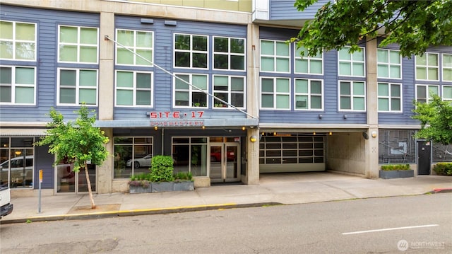 2440 Western Ave Unit 807, Seattle, WA 98121 - view of building exterior with concrete driveway and an attached garage