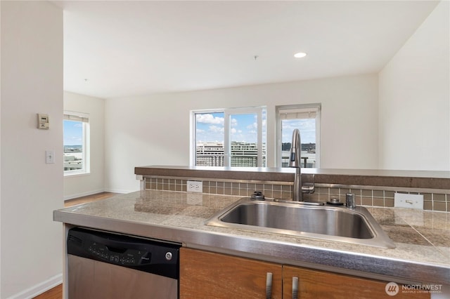 2440 Western Ave Unit 807, Seattle, WA 98121 - kitchen featuring stainless steel dishwasher, tile counters, brown cabinetry, and recessed lighting