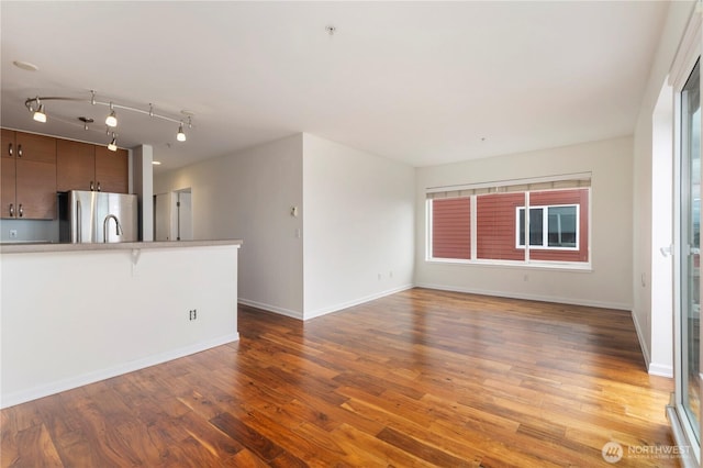 2440 Western Ave Unit 807, Seattle, WA 98121 - unfurnished living room featuring wood finished floors and baseboards