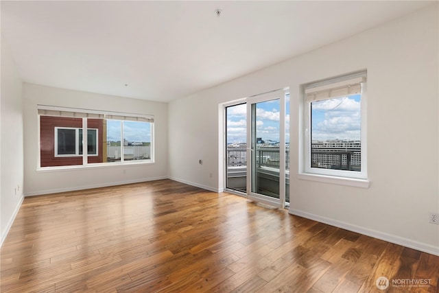 2440 Western Ave Unit 807, Seattle, WA 98121 - unfurnished room featuring plenty of natural light and wood finished floors