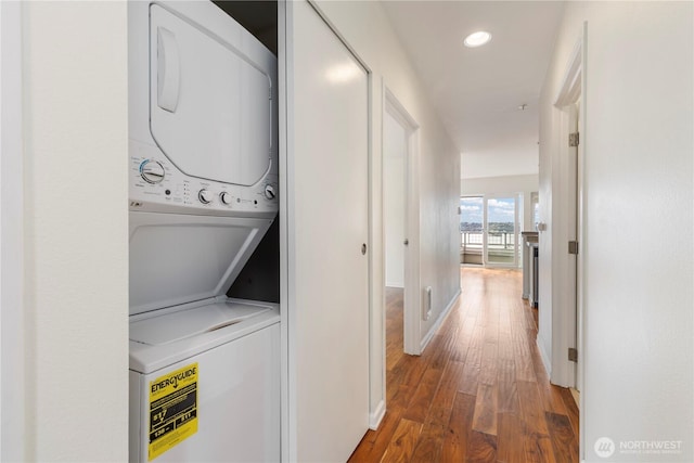2440 Western Ave Unit 807, Seattle, WA 98121 - laundry room featuring stacked washer / drying machine, wood finished floors, and recessed lighting