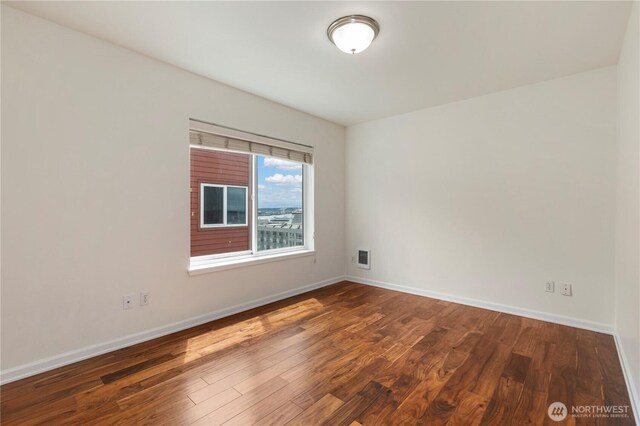 2440 Western Ave Unit 807, Seattle, WA 98121 - empty room featuring wood finished floors and baseboards