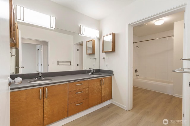 2440 Western Ave Unit 807, Seattle, WA 98121 - full bath with double vanity, wood finished floors, and shower / tub combination