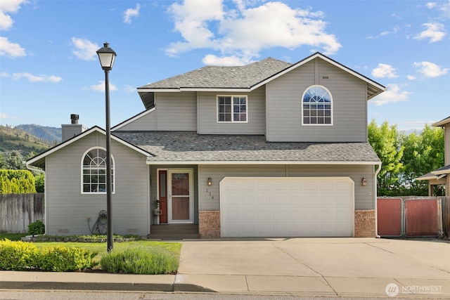 114 Creekside Pl, Cashmere, WA 98815 - view of front of home featuring brick siding, driveway, an attached garage, and a mountain view
