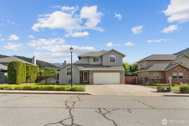 114 Creekside Pl, Cashmere, WA 98815 - traditional-style home with brick siding, concrete driveway, and a garage