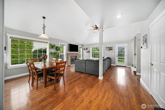 114 Creekside Pl, Cashmere, WA 98815 - dining room with ceiling fan, baseboards, a brick fireplace, dark wood-type flooring, and vaulted ceiling