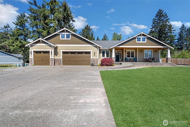 9440 Piperhill Dr SE, Olympia, WA 98513 - craftsman-style home featuring an attached garage, a porch, concrete driveway, and stone siding