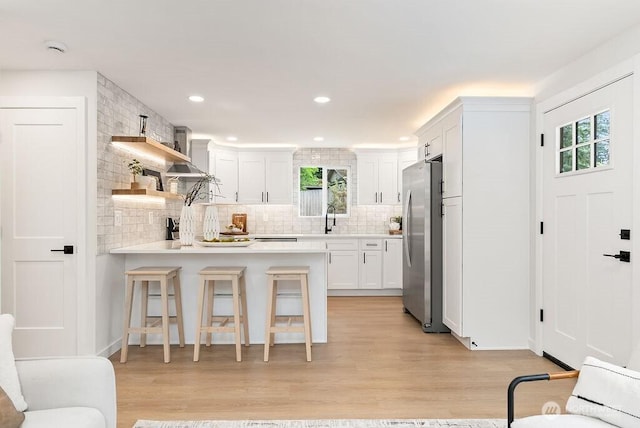 24212 SE 223rd St, Maple Valley, WA 98038 - kitchen featuring freestanding refrigerator, open shelves, a peninsula, backsplash, and a sink
