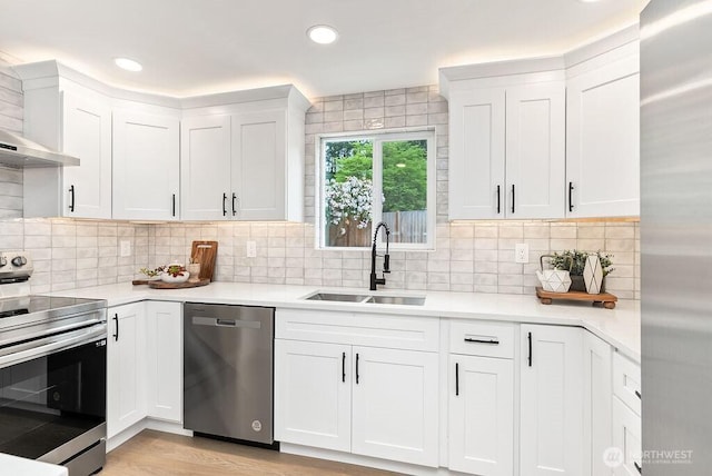 24212 SE 223rd St, Maple Valley, WA 98038 - kitchen featuring appliances with stainless steel finishes, a sink, light countertops, white cabinets, and tasteful backsplash