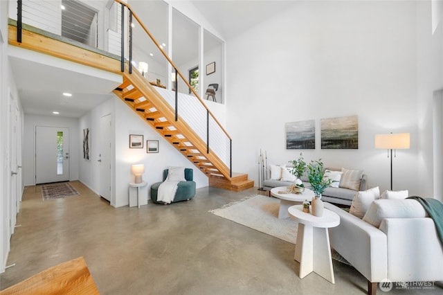 13703 Tastad Rd, Arlington, WA 98223 - living area with a high ceiling, concrete flooring, stairway, and recessed lighting