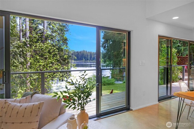 13703 Tastad Rd, Arlington, WA 98223 - doorway to outside with a water view, concrete floors, healthy amount of natural light, and recessed lighting