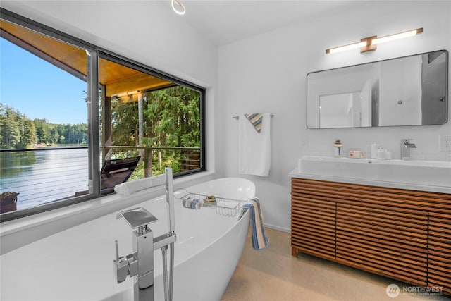 13703 Tastad Rd, Arlington, WA 98223 - full bathroom with a freestanding bath, double vanity, and baseboards